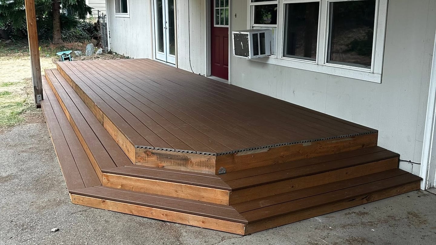 Finished deck with full-width steps under a covered patio