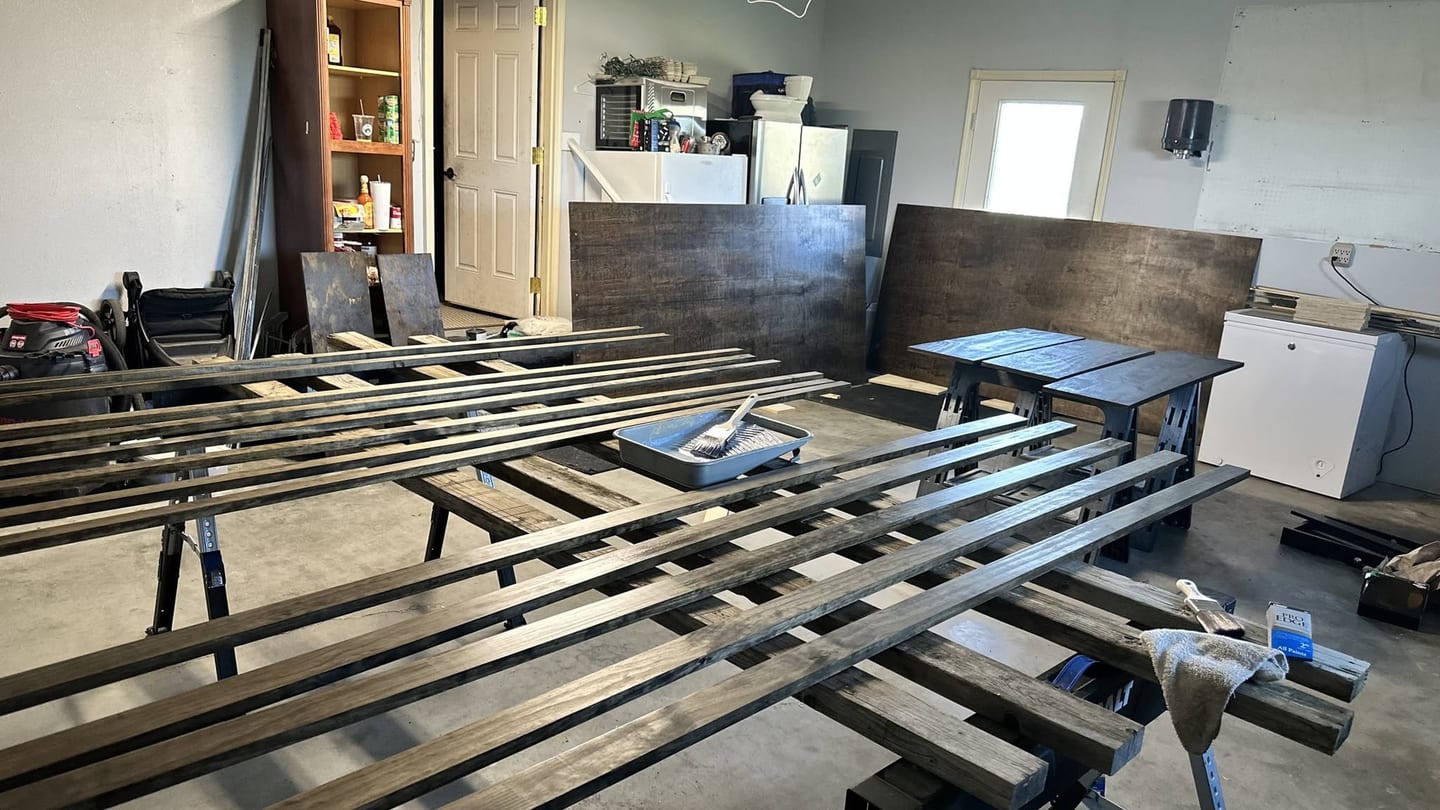 Dark stained panels laid out on sawhorses in the RockBuilt shop