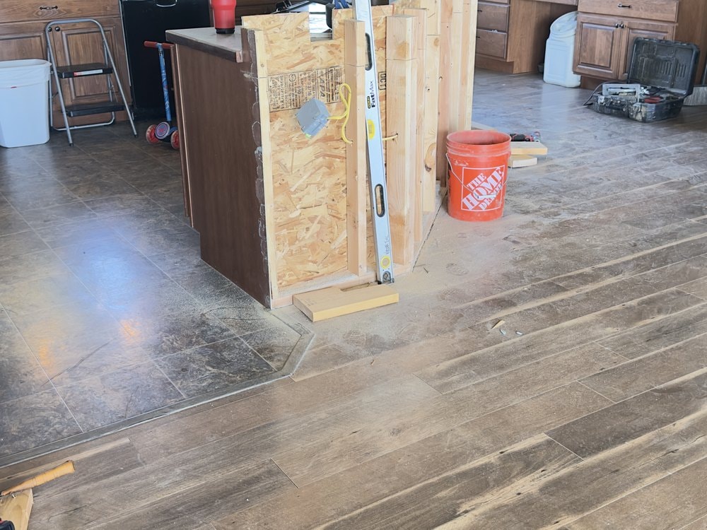 Stud and sheathing framing for the new island base with a level leaning against it